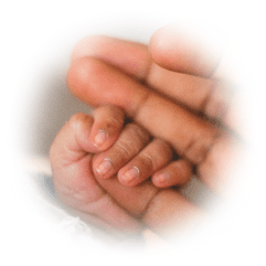 Baby's hand grasping parent's finger
